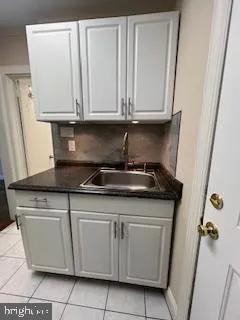 a stove top oven sitting inside of a kitchen