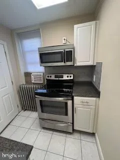 a kitchen with a stove and a microwave