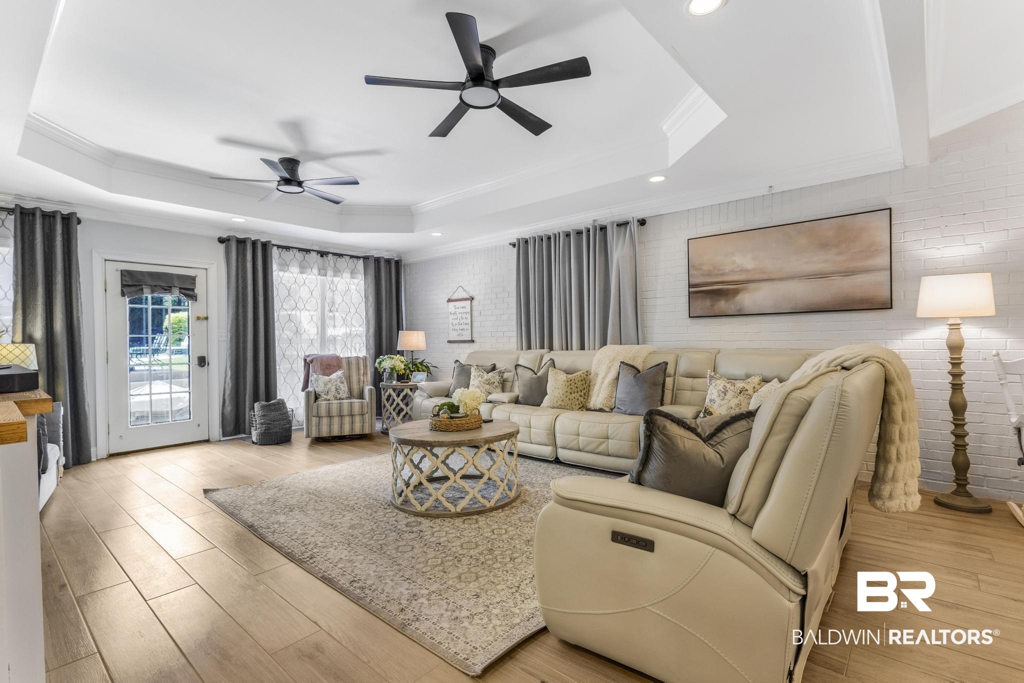 83 Caisson Trace Daphne, AL 36527 - Photo 28 of 63 Spacious living area featuring light wood-finish flooring and a white tray ceiling with recessed lighting