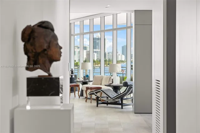 a living room with furniture and a floor to ceiling window