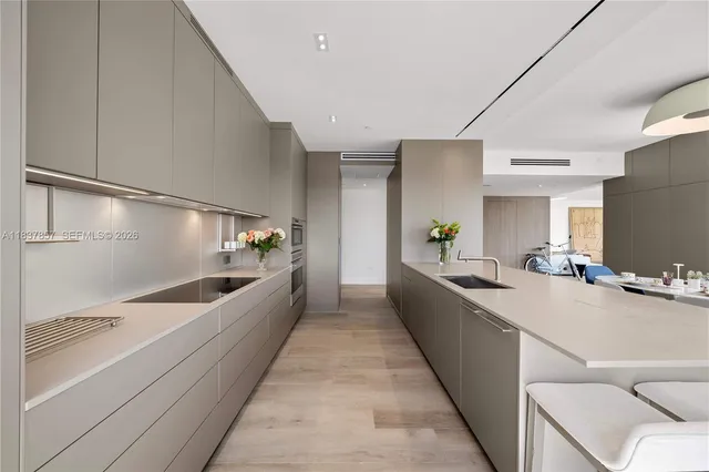 a large white kitchen with a large window