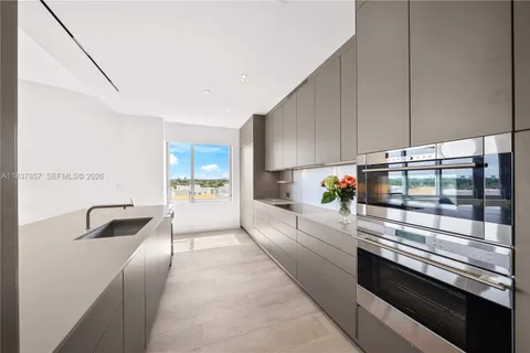 a kitchen with stainless steel appliances a stove a sink and a refrigerator