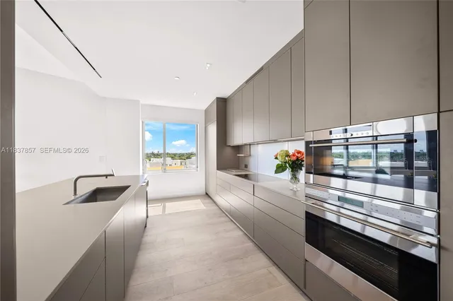 a kitchen with stainless steel appliances a stove a sink and a refrigerator