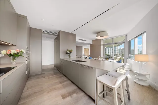 a large white kitchen with a table and chairs