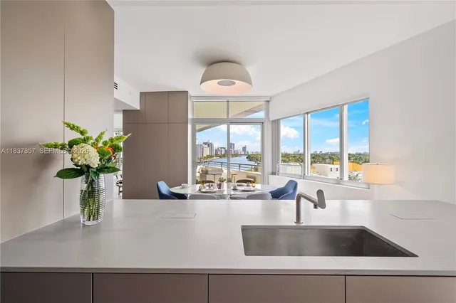 a kitchen with a sink and a large window