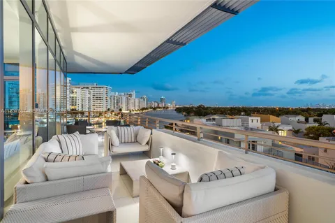 a living room with furniture and a kitchen view