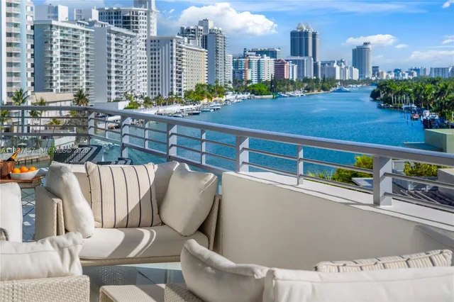 a view of a chairs and table in the balcony