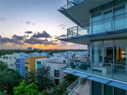 a view of swimming pool with seating space and trees in the background