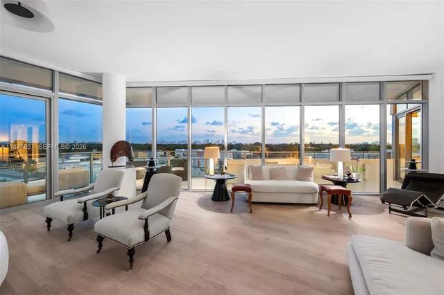 a living room with furniture and large windows
