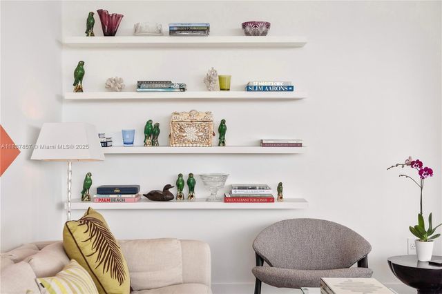 a workspace with a refrigerator and a wooden floor