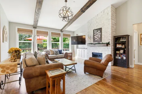 a living room with furniture a rug and a chandelier