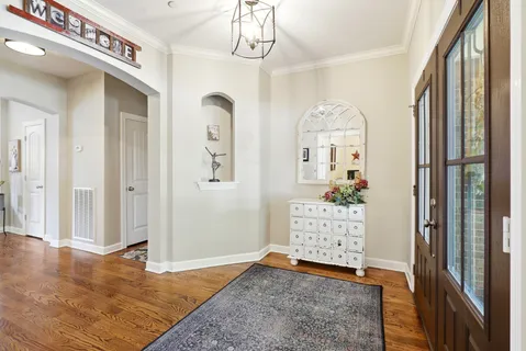 a view of a workspace with furniture and a chandelier