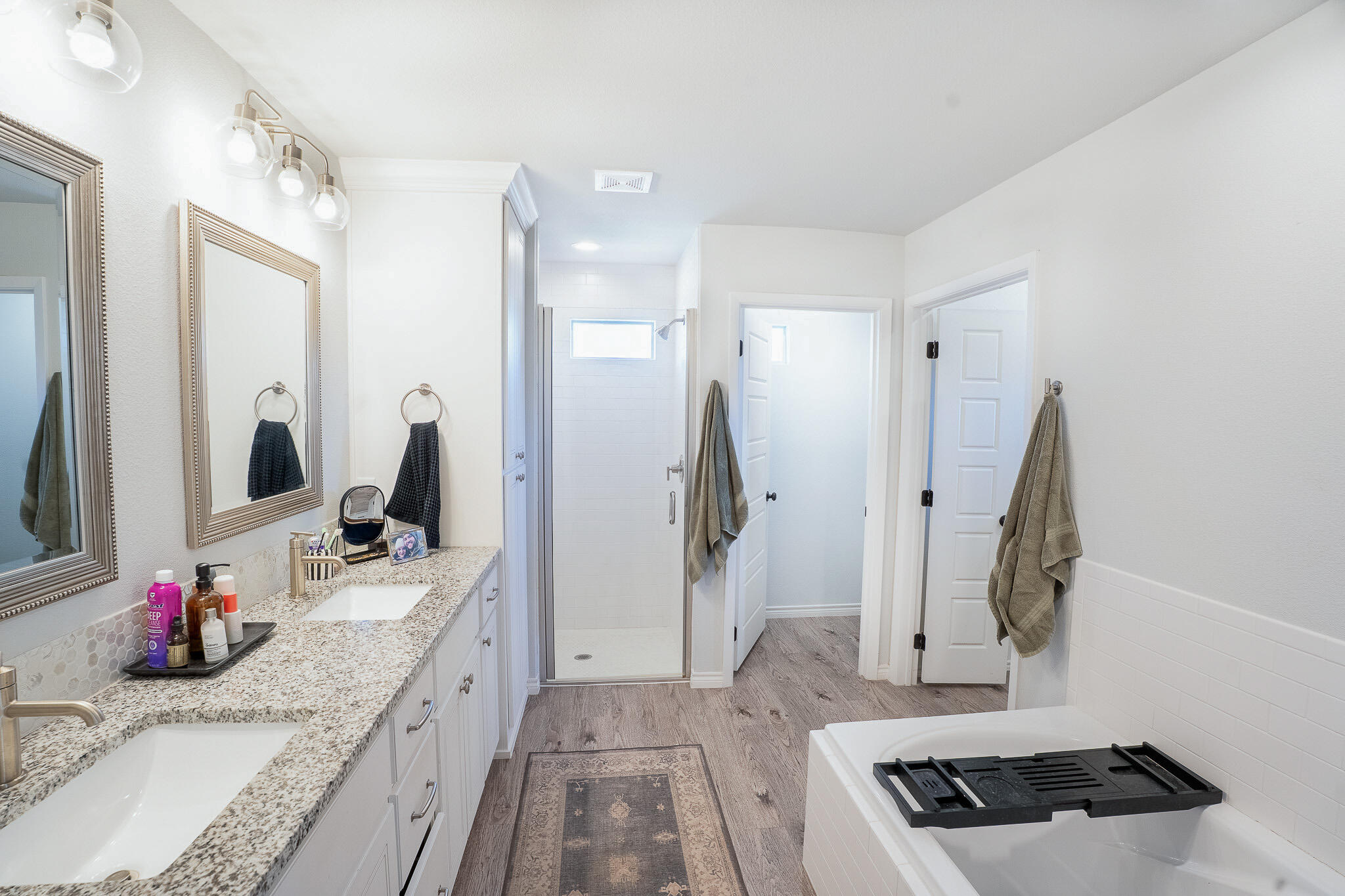 3436 125th Street Lubbock, TX 79423 - Photo 11 of 22 a bathroom with sink a mirror and shower