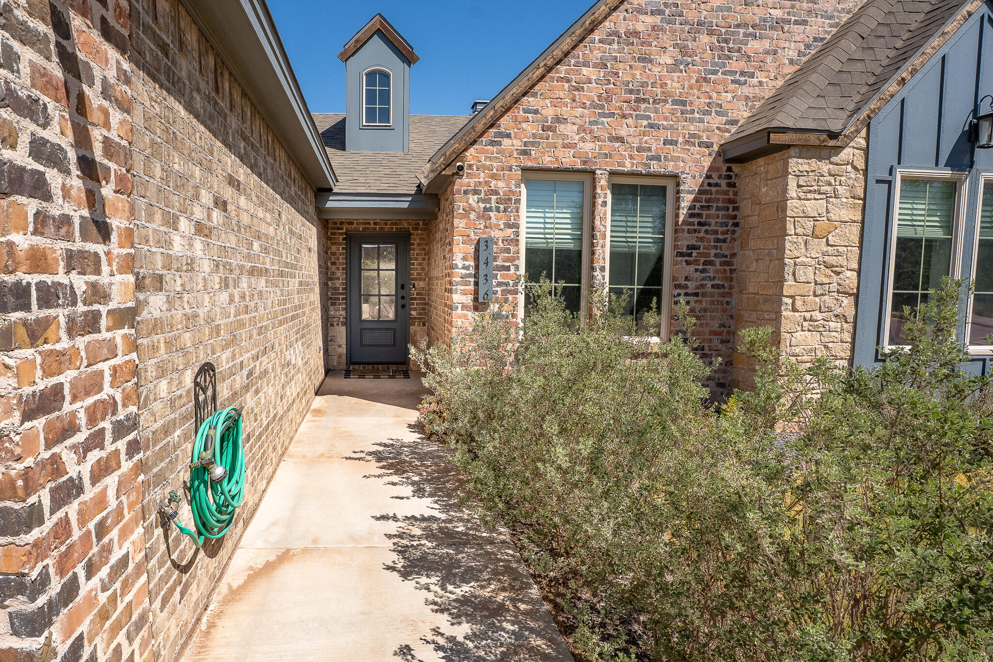 3436 125th Street Lubbock, TX 79423 - Photo 19 of 22 front view of a brick house with a large window