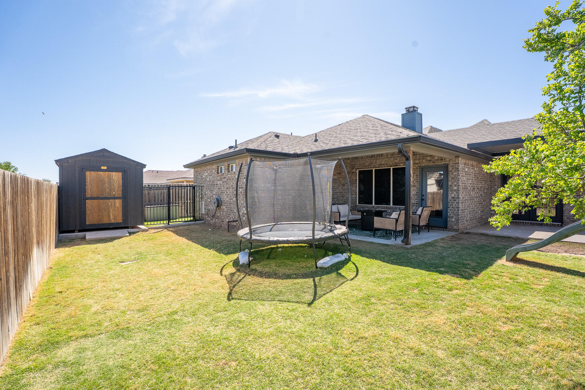 3436 125th Street Lubbock, TX 79423 - Photo 21 of 22 a view of a house with swimming pool and sitting area