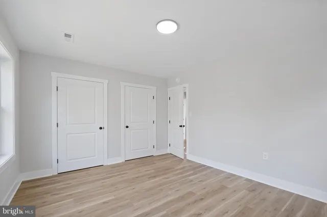 a view of an empty room and wooden floor