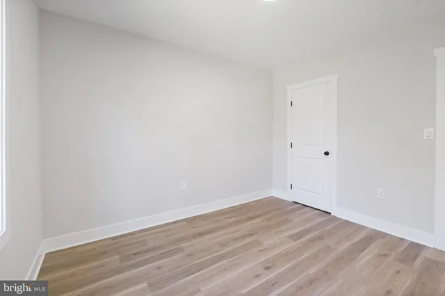 an empty room with wooden floor