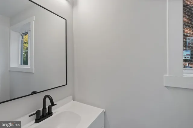 a bathroom with a sink and mirror
