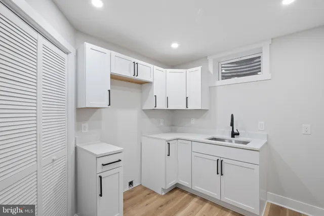 a kitchen with a sink cabinets and window