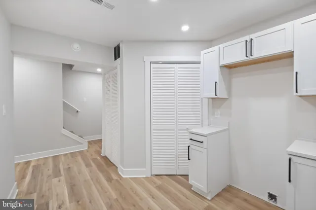a view of empty room with wooden floor