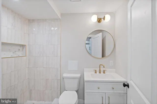 a bathroom with a toilet sink and mirror