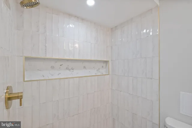 a bathroom with a toilet a sink and a mirror