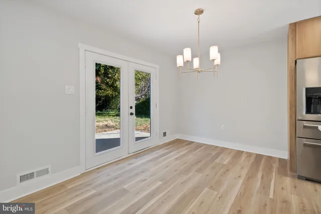 a view of a big house with a yard and plants