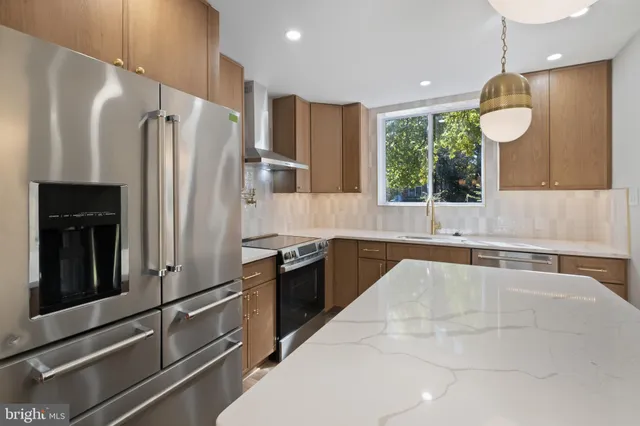 a large kitchen with cabinets and stainless steel appliances