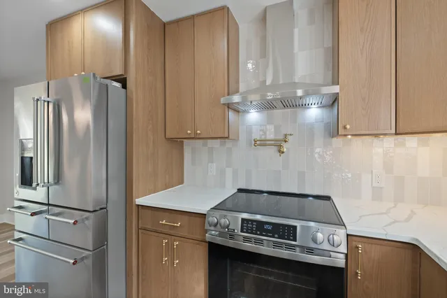 a kitchen with a stove and a refrigerator