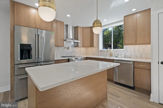 a kitchen with a refrigerator a sink and cabinets