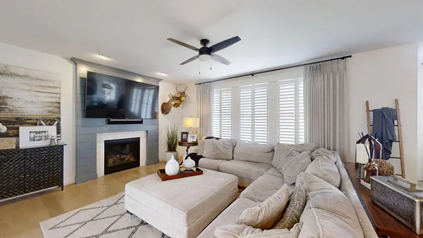 a living room with furniture fireplace and flat screen tv