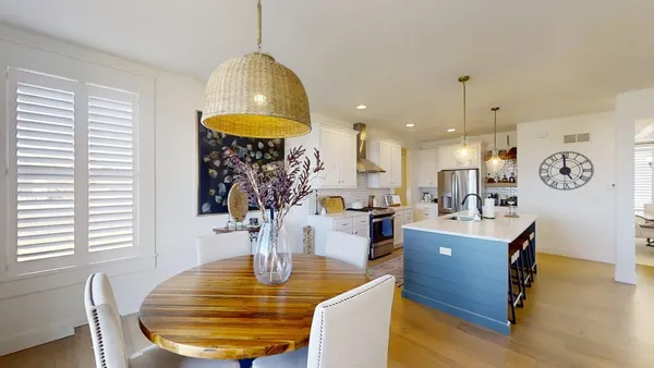 a kitchen with stainless steel appliances granite countertop a sink a stove and refrigerator