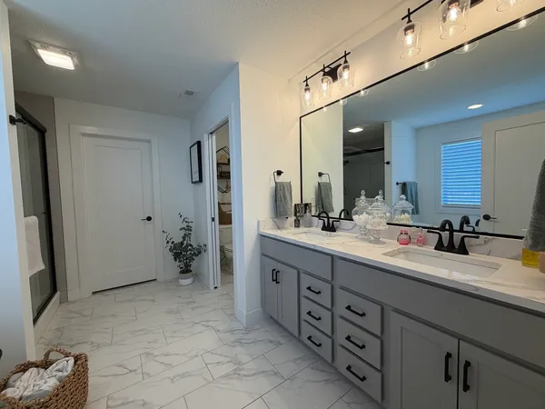 a bedroom with a bed and a chandelier