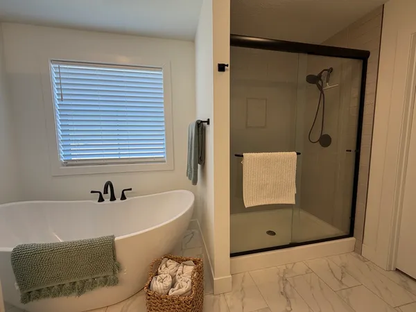 a bedroom with a large bed and a ceiling fan