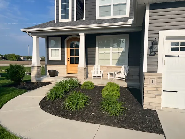 a front view of a house with garden