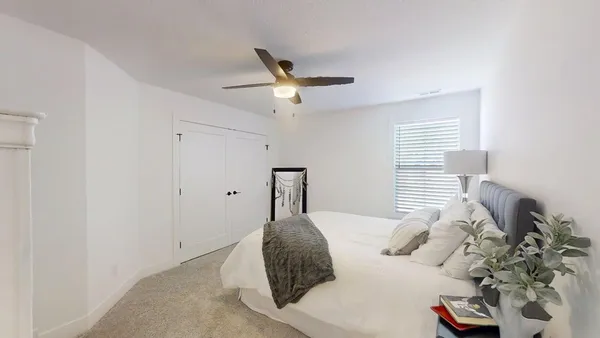 a bedroom with a bed and window