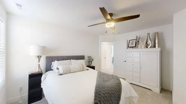 a bedroom with a bed and a dresser