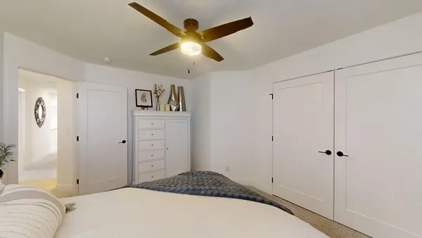 a bedroom with a bed and a chandelier