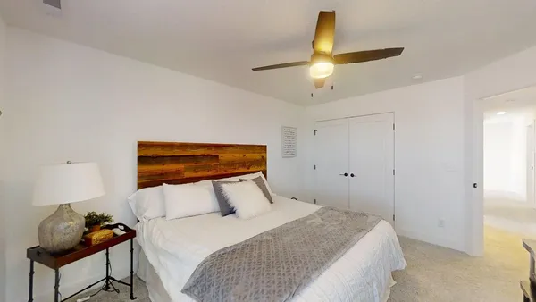 a bedroom with a bed and a chandelier