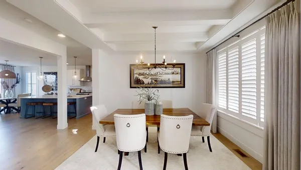 a view of a dining room with furniture and a chandelier