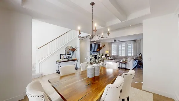 a living room with furniture and a chandelier