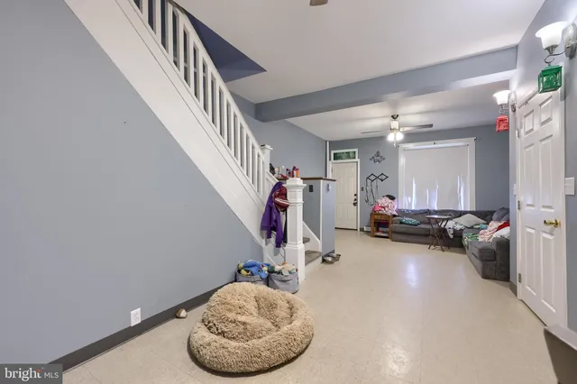 a view of a tiny house with a yard covered with snow