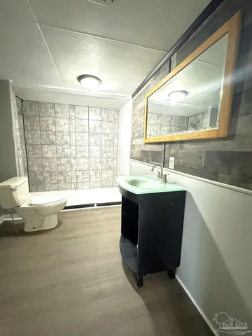 a bathroom with a large tub sink and double vanity