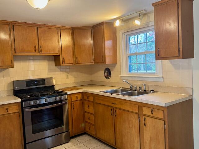 a kitchen with stainless steel appliances a stove sink and cabinets