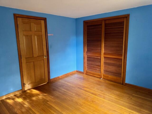 22 Cranberry Lane Centerville, MA 02632 - Photo 3 of 10 a view of an empty room with a wooden door