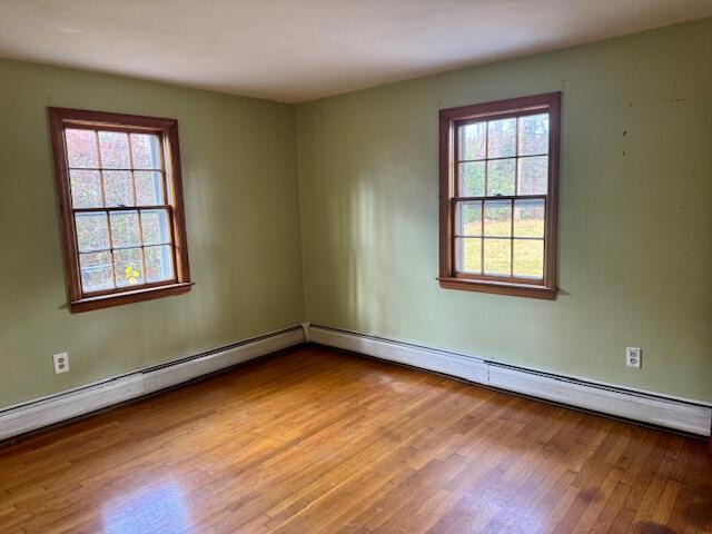 22 Cranberry Lane Centerville, MA 02632 - Photo 4 of 10 an empty room with wooden floor and windows