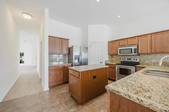a kitchen that has a sink and a stove in it