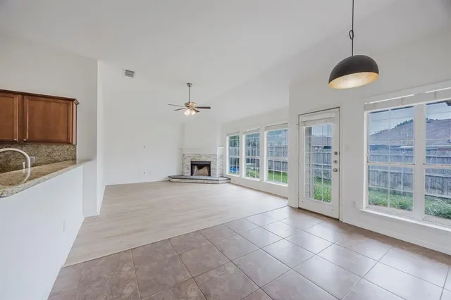 a view of a kitchen with granite countertop a sink and a stove