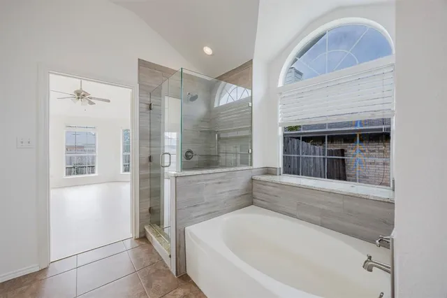 a bathroom with a bathtub and shower