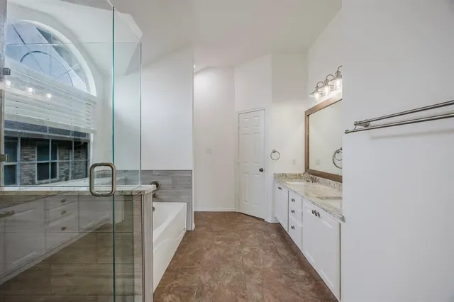 a bathroom with granite countertop a sink and a mirror